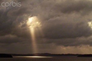 Norway, Bergen, Light shining through clouds in field